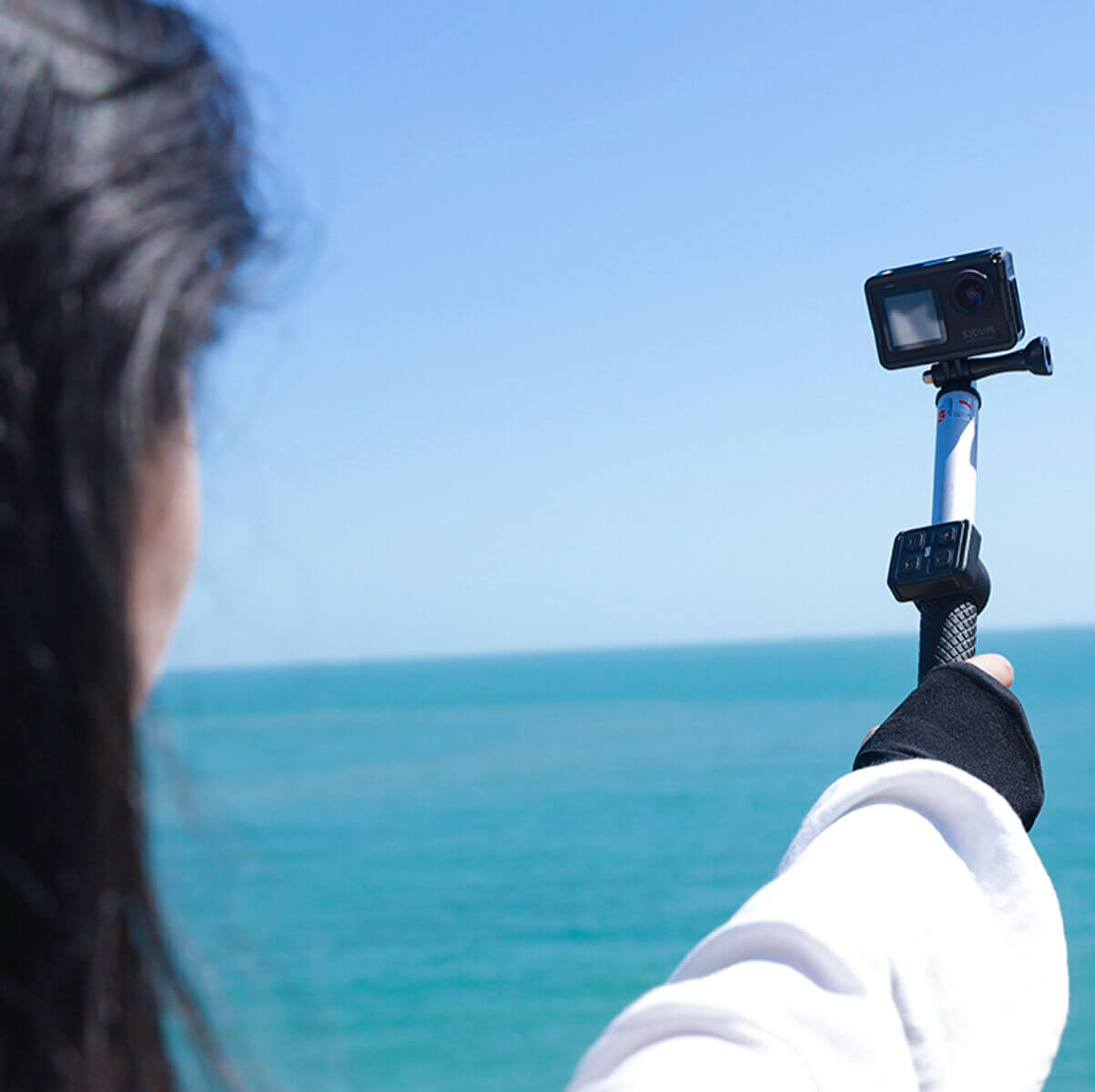 Using a Remote Selfie Stick to capture a photo by the ocean