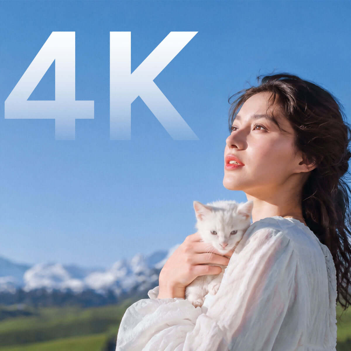 4K video quality showcasing a woman holding a white kitten against a scenic landscape.